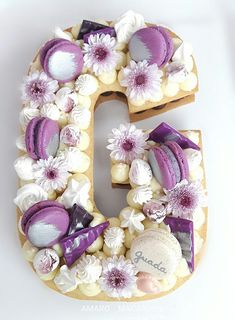 the letter g is made up of cookies and candies with flowers on it's sides