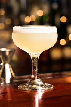 a white drink sitting on top of a wooden table