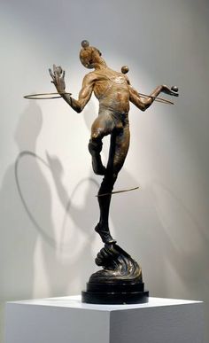 a bronze statue is on display in a museum