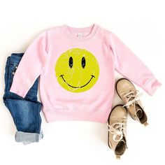 Looking for a cute sweatshirt for your kids? We have the perfect Distressed Smiley Face graphic sweatshirt addition to their closet! Also available in youth sweatshirts. Winter Fun Sweatshirt With Cartoon Print, Fun Winter Sweatshirt With Cartoon Print, Cute Hoodie With Cartoon Print And Crew Neck, Cute Cartoon Print Hoodie With Crew Neck, Cute Cartoon Print Crew Neck Hoodie, Playful Hoodie With Graphic Print For Spring, Playful Spring Hoodie With Graphic Print, Cute Long Sleeve Sweatshirt For School, Playful Graphic Print Hoodie For Spring