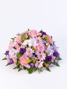 a bouquet of pink and purple flowers on a white background