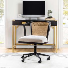 an office chair sits in front of a desk with a computer monitor on top of it