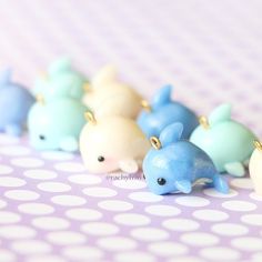 small blue and white dolphin figurines lined up on a polka dot tablecloth