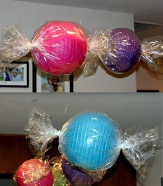 some balls are wrapped in plastic and hanging from the ceiling