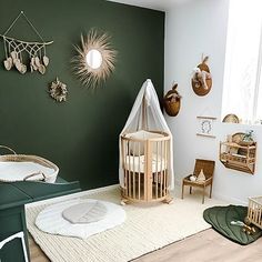 a baby's room with green walls and white rugs