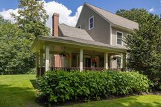 a house that has bushes in front of it