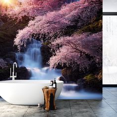 a bath tub sitting next to a waterfall in the middle of a bathroom wall mural