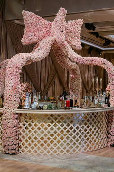 Luxurious floral bar arrangement at The Glasshouse in New York, featuring thousands of delicate pink roses forming an exquisite bow shape. Perfect for high-end events and weddings. Floral Bar Arrangement, Bar Facade, Arch Installation, Bar Arrangement, Wedding Food Bars, Event Space Design, Zhoushan, Rose Arch, Floral Bar