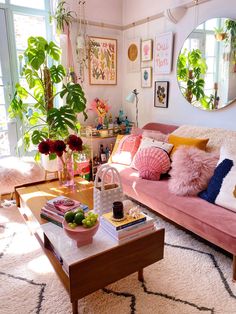 a living room filled with lots of furniture and flowers in vases on top of a table