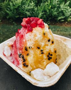 a piece of cake sitting on top of a paper plate covered in berries and powdered sugar