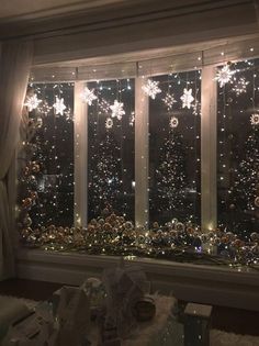 the window is decorated with snowflakes and lights