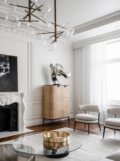 a living room filled with furniture and a fire place next to a painting on the wall