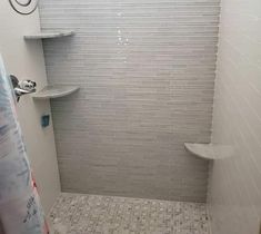 a walk in shower sitting next to a toilet