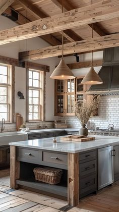 a large kitchen with an island in the middle and lots of windows on both sides