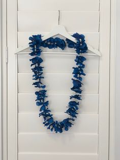 a blue necklace hanging on a white door