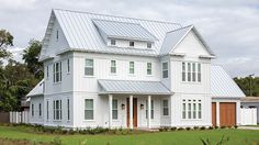 a large white house sitting on the side of a road