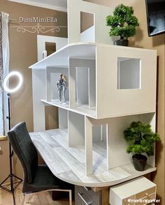 a doll house is sitting on top of a desk