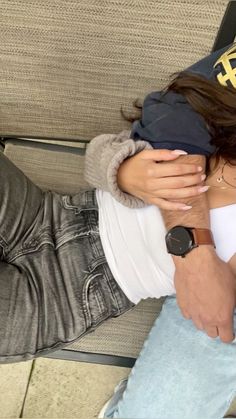 a man and woman hugging each other on a couch