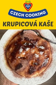 a person holding a white plate with food on it and the words czech cooking krupicova kase