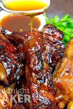 barbecue ribs with sauce being drizzled over them