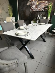 a dining room table with plates and place settings