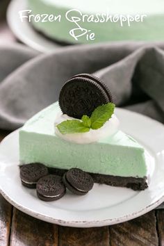 a slice of frozen grasshopper pie on a plate with oreo cookies and mint