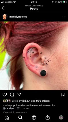 a woman with red hair wearing pink ear piercings