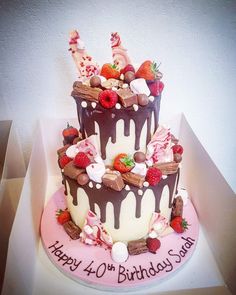 a birthday cake decorated with chocolate and strawberries