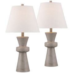 two lamps with white linen shades on each lamp and one is turned off to the side