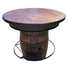 a wooden barrel table with an iron base