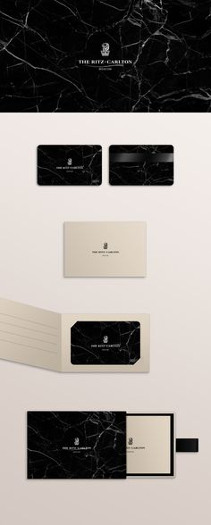 some black and white business cards on top of each other