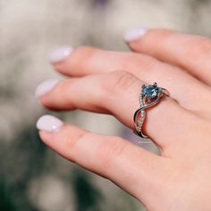 The entwined lovers knot is a symbol of everlasting devotion. This ring is perfect to wear as engagement ring, promise ring, birthstone ring, or statement piece.►Average band width: 2.3 mm►True to size.Center Stone: AquamarineColor: BlueGemstone creation: lab-created Shape: RoundMeasurements: 6.0 mmCarat Weight: 1.1 ct. (approx.)Cut: BrilliantAccent stones: Simulated diamonds (CZ)✓ Comfort Fit✓ Free Ring Box✓ Free USA Shipping✓ Ready to ship next business day Modern Twist Promise Ring, Modern Twist Round Cut Rings For Anniversary, Fine Jewelry Infinity Ring For Anniversary, Elegant Promise Stackable Rings With Birthstones, Adjustable Infinity Promise Ring, White Gold Rings With Modern Twist For Promise, Cubic Zirconia Infinity Jewelry For Promise, Solitaire Promise Ring With May Birthstone, Promise Diamond Ring With May Birthstone In Round Cut