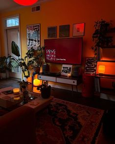 a living room filled with furniture and a flat screen tv sitting on top of a wooden table