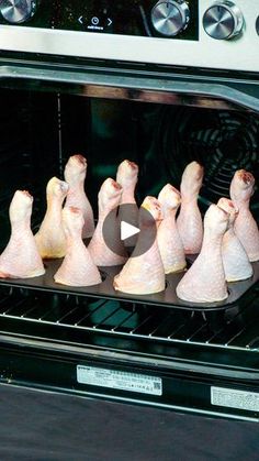 chicken legs are being cooked in an oven