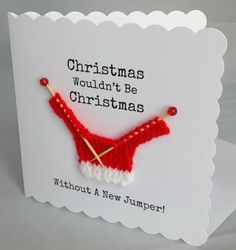 a christmas card with a red knitted bra hanging from it's side and the words, christmas wouldn't be christmas without a new jumper