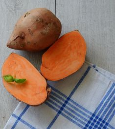 two sweet potatoes sitting on top of a blue and white towel