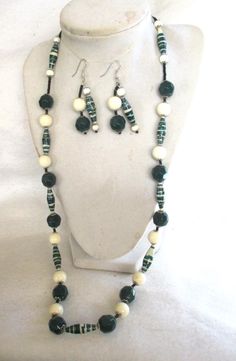 a necklace and earring set with beads on a mannequin headpieces