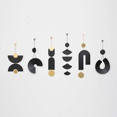 the word art is made out of black and gold metal letters with circles, shapes, and dots