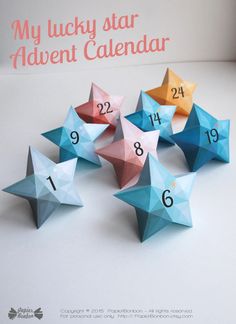 a bunch of stars that are on top of a white table with the words my lucky star adventent calendar