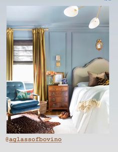 a bedroom with blue walls and gold curtains