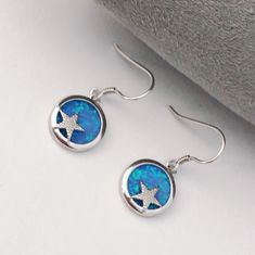 "Blue Opal Sterling Silver Starfish Earrings, Fire Opal Earrings, Star Earrings, Starfish jewellery, Neptune jewellery beach jewelry. Total size: 11*23mm Sterling silver blue opal starfish earrings inspired by my beautiful island of Jersey. Plated with triple layers of 18ct white gold, this sterling silver necklace is anti-tarnishing. Pendant comes with a 18 inch sterling silver curb chain with 18ct white gold plating. Contact me for other length of chains. Why do I love to use Opal in my design Blue Starfish Charm Earrings For Gift, Blue Star-shaped Sterling Silver Earrings, Blue Sterling Silver Star Earrings, Blue Opal Jewelry, Starfish Jewelry, October Birthstone Necklace, Fire Opal Earrings, Earrings Star, Starfish Earrings