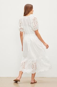 Crafted from embroidered cotton lace, this dress boasts a v-neckline, raglan seams, and puff sleeves for a classic, sophisticated aesthetic. The drawstring waist, inseam pockets, and detachable slip enhance the practicality of this timeless piece, ensuring a versatile and polished look for the season. Lace Boho Dress, Cotton Lace Dress, Lace Dress Boho, Velvet Tees, Embroidered Lace Dress, Cotton Lace, Embroidered Lace, Polished Look, Velvet Dress