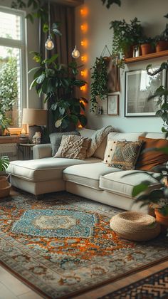 a living room filled with furniture and lots of plants