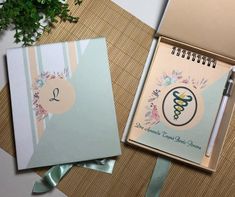 a notepad with a medical symbol on it next to an open notebook and pen