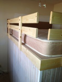 two wooden bunk beds sitting next to each other