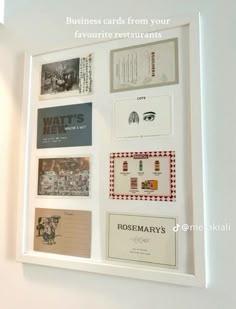 a white frame holding several business cards and envelopes on the wall with text that reads, business cards from your favorite restaurants