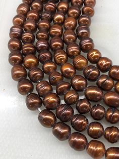 some brown beads on a white surface