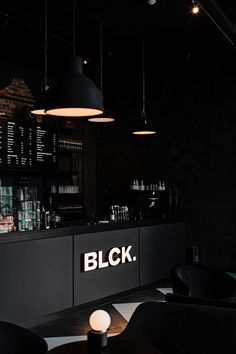 the bar is lit up at night with black lighting