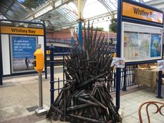 a large iron throne sitting in the middle of a train station