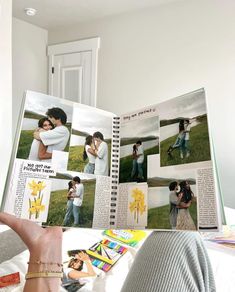 a person holding up an open book with pictures on it